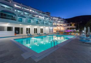 a large swimming pool in front of a building at Asteria Hotel in Tolo