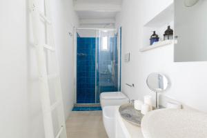 a bathroom with a toilet and a sink and a mirror at Appartamento Al Bastione by BarbarHouse in Otranto +21 photos