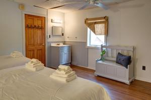 a bedroom with a bed with towels on it at Pine Hill Arms Hotel in Pine Hill