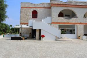 a building with a staircase and a patio at Villa Santo Stefano in Monopoli