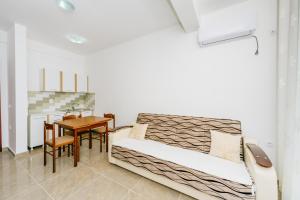 a small room with a bed and a table at Teuta Apartments in Ulcinj