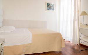 Postel nebo postele na pokoji v ubytování Hotel Nettuno