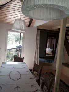 a dining room with a table and chairs and a window at Fisherman's Cottage in Cacica
