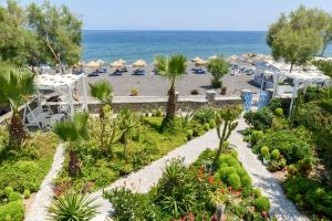a view of a beach with umbrellas and the ocean at Ocean Bay Suites in Kamari