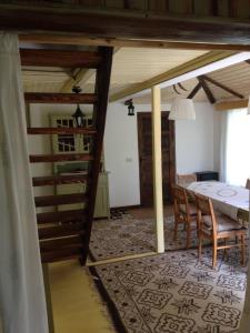 a room with a table and chairs and a dining room at Fisherman's Cottage in Cacica