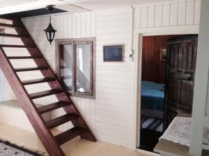 a staircase leading to a room with a bedroom at Fisherman's Cottage in Cacica +9 photos