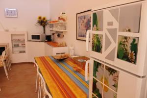 a kitchen and dining room with a table and a refrigerator at B&B Pizzo Cannicchio in Matera