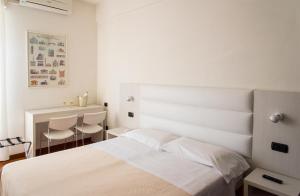 Postel nebo postele na pokoji v ubytování Hotel Nettuno