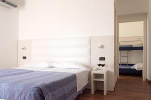Postel nebo postele na pokoji v ubytování Hotel Nettuno