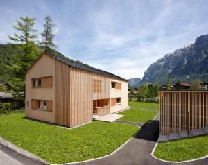a house with a mountain in the background at Ferienhaus Islen in Mellau