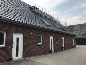 a red brick building with a staircase on top of it at Ferienwohnung Hagener Meer in Mehrhoog