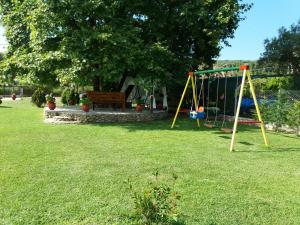 a swing set in a yard with a bench at Vourvourou Antonis House in Vourvourou