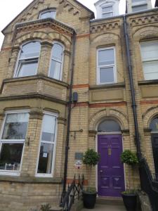 a purple door on a brick house at Moorgarth Guesthouse in York