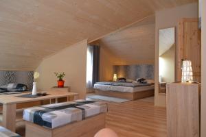 a bedroom with two beds and a wooden ceiling at Penzion Manderlak in Liptovský Mikuláš