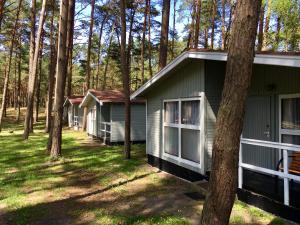 a row of cottages in the woods at Leśna Przystań in Pobierowo