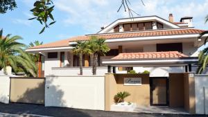 a house in the suburbs with palm trees at Borea Luxury B&B in Pescara