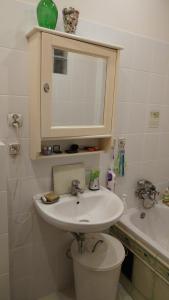 a bathroom with a sink and a toilet and a mirror at W kamienicy in Gdańsk +9 photos