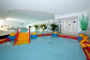 a large indoor swimming pool in a building at Apart Sunshine in Ladis