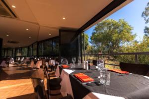a restaurant with tables and chairs and a large window at Discovery Resorts - Kings Canyon in Kings Canyon