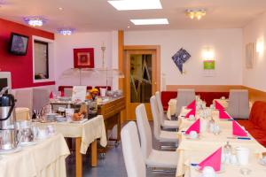 a restaurant with tables and chairs in a room at 1a Hotel Steiner in Judenburg