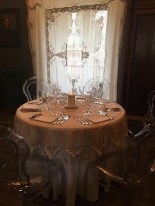 a table with wine glasses and a candle on it at B&B Santapau Charme Living in Licodia Eubea