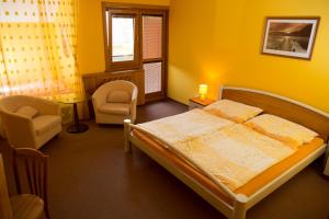 A bed or beds in a room at Penzion Jople