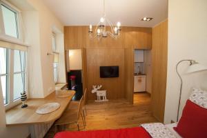 a living room with a dining room table and a room with a bed at My place in Poznan in Poznań