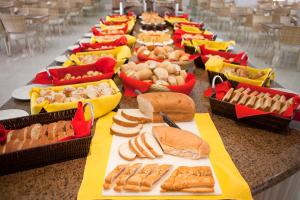 una larga mesa llena de diferentes tipos de alimentos en Prive Riviera Thermas - OFICIAL, en Caldas Novas