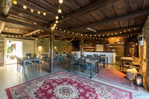a dining room with tables and chairs and a rug at Vetsi Talli Holiday Village in Kassari