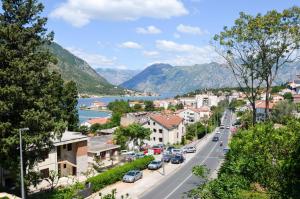 a view of a town with a lake and mountains at Bay View Apartments in Kotor