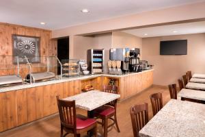 a restaurant with tables and chairs and a counter at Ayres Lodge Alpine in Alpine