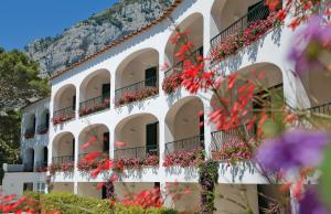 a building with flowers on the balconies at Hotel Della Piccola Marina in Capri