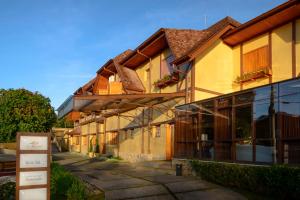 a row of buildings with windows on a street at Hotel Le Renard - Campos do Jordao in Campos do Jordão