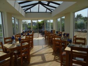 a dining room with tables and chairs and windows at Lutwidge Arms in Holmrook +33 photos
