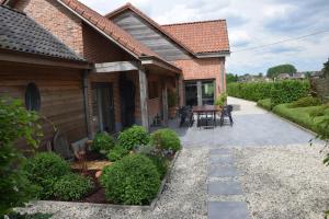 une terrasse d'une maison avec une table et des chaises dans l'établissement B&B De Nootelaer, à Meldert