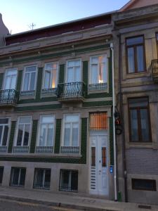 a building with white doors and windows on a street at Porto Alive in Porto