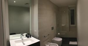 a white bathroom with a sink and a toilet at Sanremo Luxury Apartament in Sanremo +17 photos