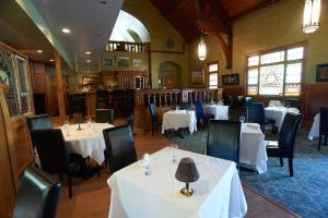 a dining room with white tables and chairs at Belfry Inn and Bistro in Sandwich