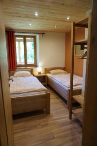 A bed or beds in a room at ecoHouse FURLAN - Apartment PINJA