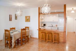 a kitchen and dining room with a table and chairs at Sunset View And Pool In Paradise in Adeje
