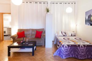 salon z łóżkiem i kanapą w obiekcie Segovia w Madrycie
