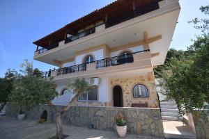 a large building with a balcony on top of it at Sofia Apartments in Koroni