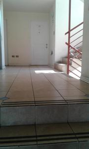 an empty room with a staircase in a building at departamento San Martin in Antofagasta +1 photo