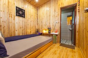 A bed or beds in a room at Little View Homestay
