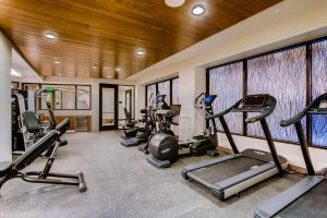 a gym with several treadmills and elliptical machines at The Lion Vail in Vail