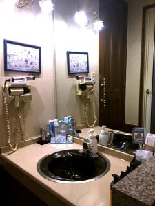 a bathroom with a sink and a mirror at Hotel Ohirune Racco Sakai (Adult Only ) in Sakai