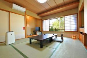 a large room with a table in a room at Otowaya Ryokan in Yuzawa