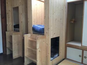 a wooden room with four bunk beds at Notrack in Niseko