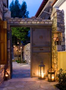 an entrance to a house with a gate with lights at Hotel Minelska Resort in Kala Nera