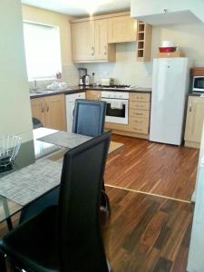 A kitchen or kitchenette at Falconwood Apartment
